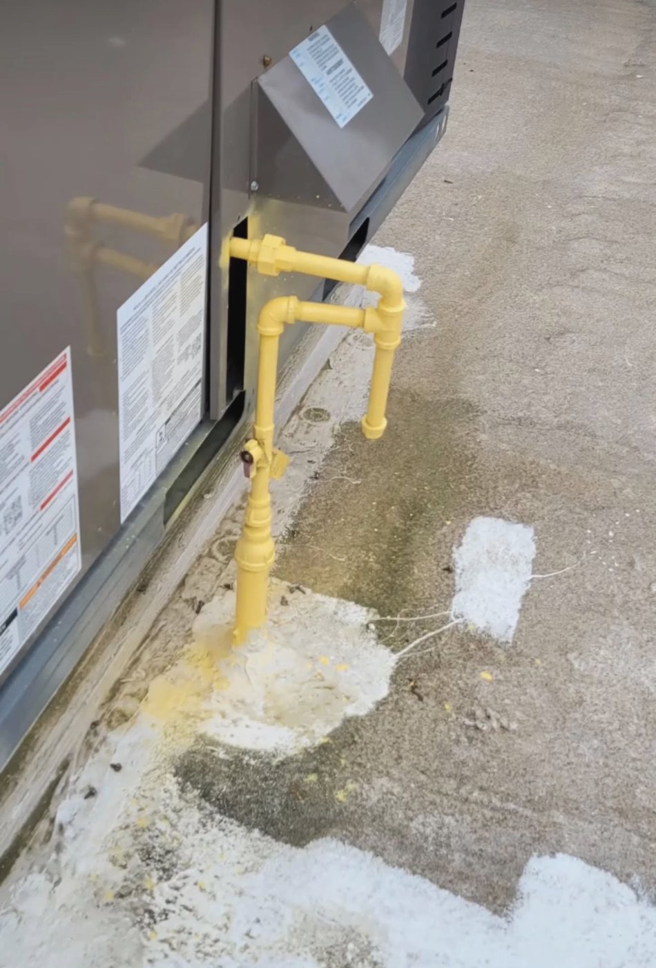Yellow gas piping with shut-off valve connected to a rooftop unit